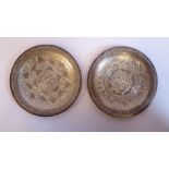 A similar pair of Middle Eastern (possibly Persian) shallow silver coloured metal dishes,