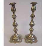 A pair of loaded silver candlesticks with embossed and chased floral and foliate ornament,