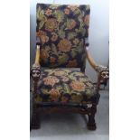 A baronial style, carved mahogany framed throne chair, the high level back, open,