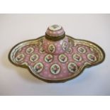 A 19thC Continental gilt metal mounted porcelain inkwell, on a matching, oval, lobed saucer,
