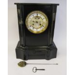 A late Victorian black slate cased, breakfront mantel clock with a flat top and straight sides,