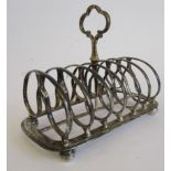 A late Victorian Scottish silver six division scrolled wire toastrack with a trefoil handle,