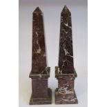 A pair of late Victorian mottled iron red marble obelisks,