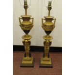 A pair of 20thC classically inspired, gilt metal and bronze finished table lamps,