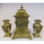 A late 19thC ornately cast brass clock garniture,