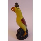 An early 20thC Continental porcelain novelty lamp base, a parrot with yellow and iron red plumage,