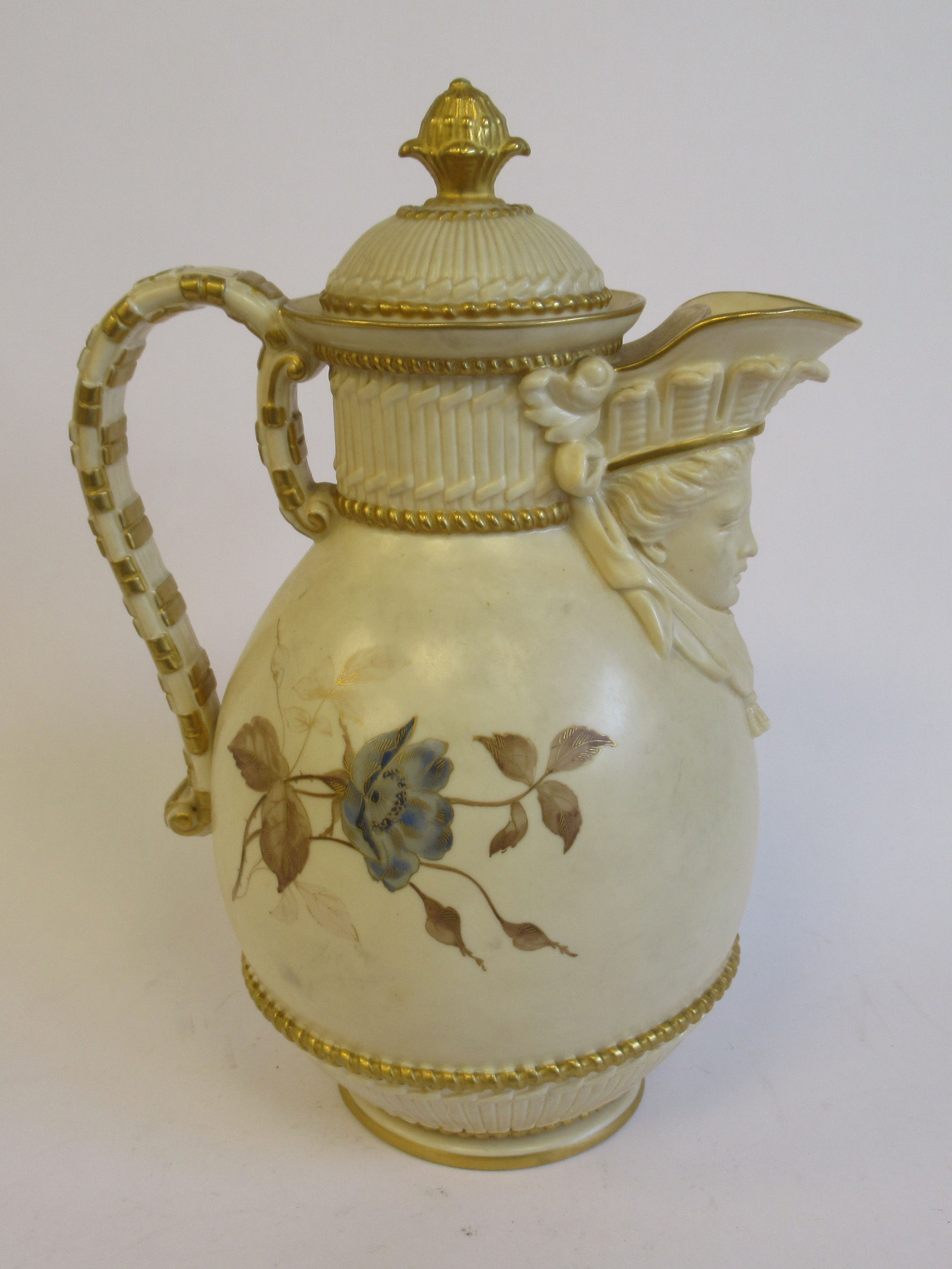 A Royal Worcester blush ivory glazed china jug of oval, bulbous form, having a scrolled loop handle,