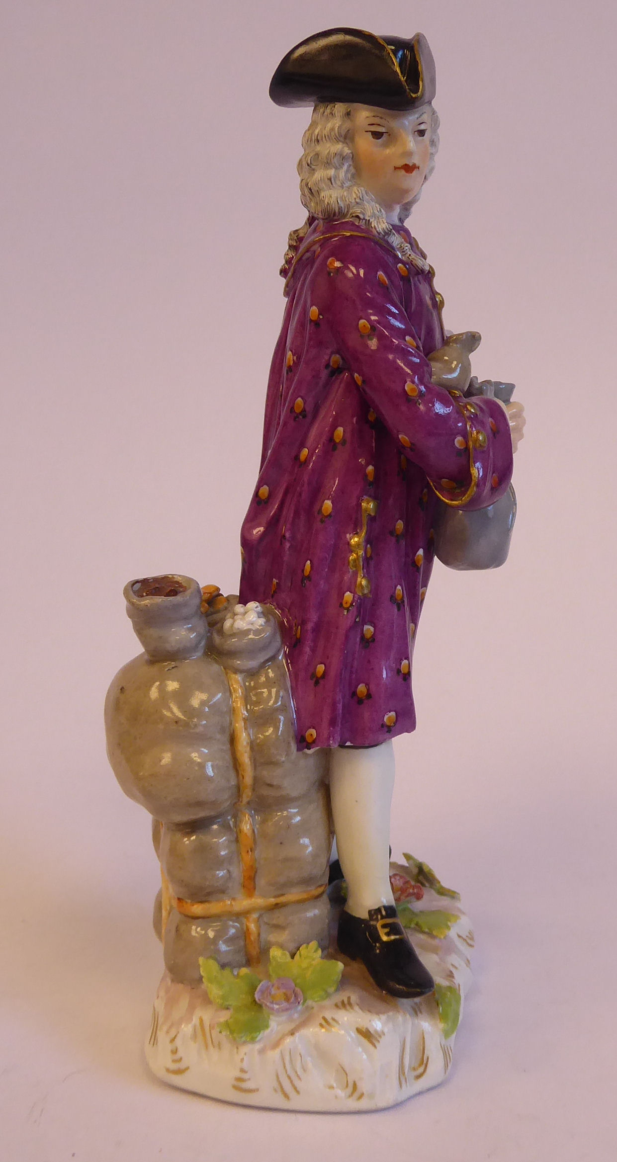 A mid 19thC Continental porcelain figure, a standing merchant, wearing a tricorn hat, wig, - Bild 2 aus 7