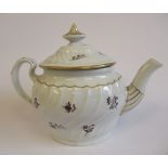 A late 18th/early 19thC New Hall porcelain teapot of oval, rib moulded ogee form,