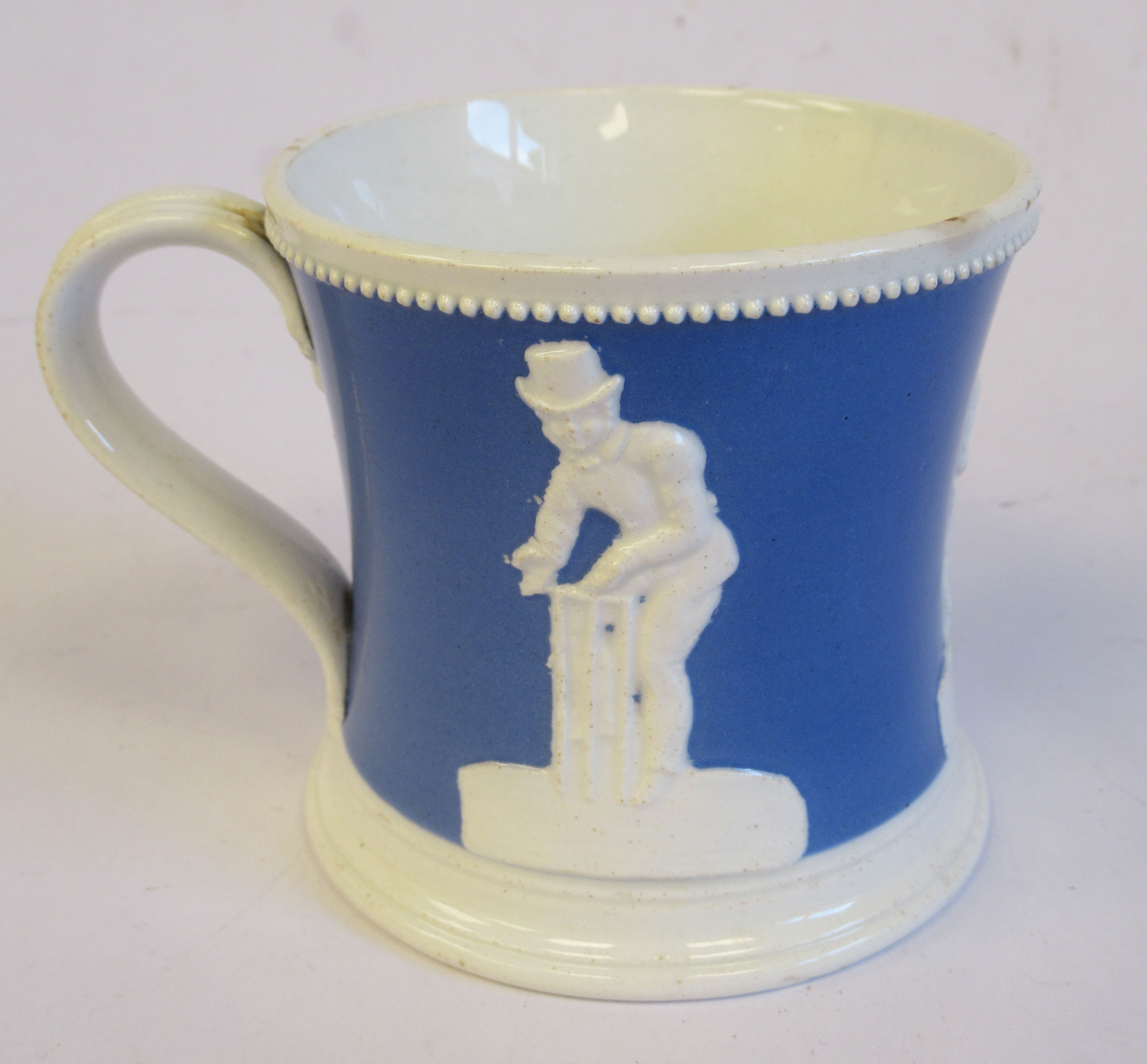 A mid 19thC powder blue and white glazed pearlware mug of waisted, cylindrical form,