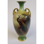 A Royal Worcester china pedestal vase of ovoid form, having a narrow neck, flared rim and twin,