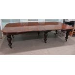 A mid Victorian mahogany wind-out dining table, the top with a thumb moulded edge,