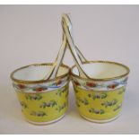 A pair of 19thC Continental porcelain conjoined bucket vases with entwined handles,