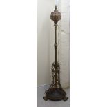 A late Victorian copper and brass lamp standard with a reservoir, over a height adjustable column,