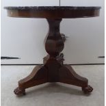 A William IV mahogany centre table with a mottled black and white marble top, over a straight,