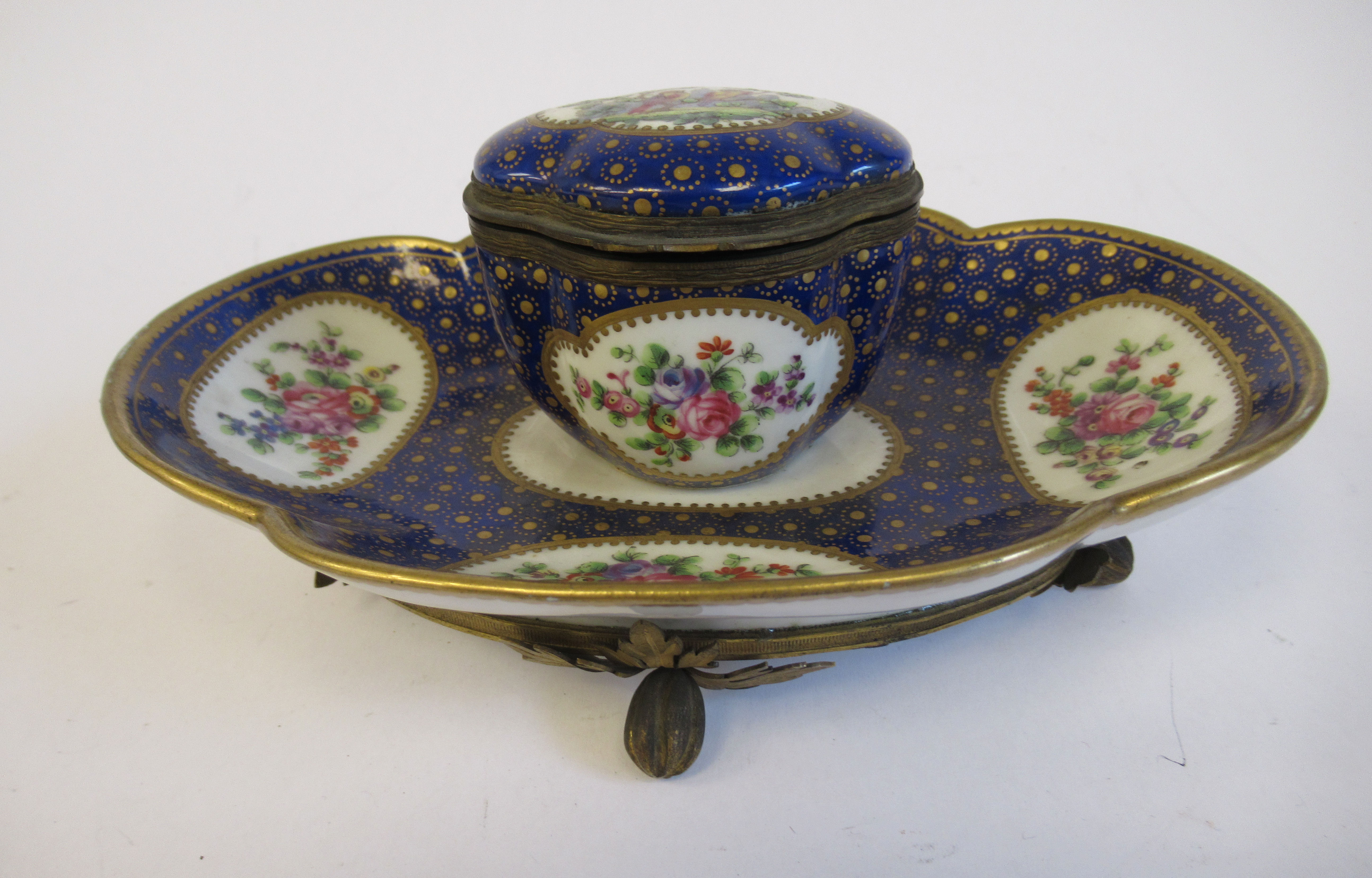 A 19thC Continental gilt metal mounted porcelain inkstand, attached to a lobed, oval saucer,