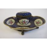 A 19thC Continental gilt metal mounted porcelain inkstand, attached to a lobed, oval saucer,