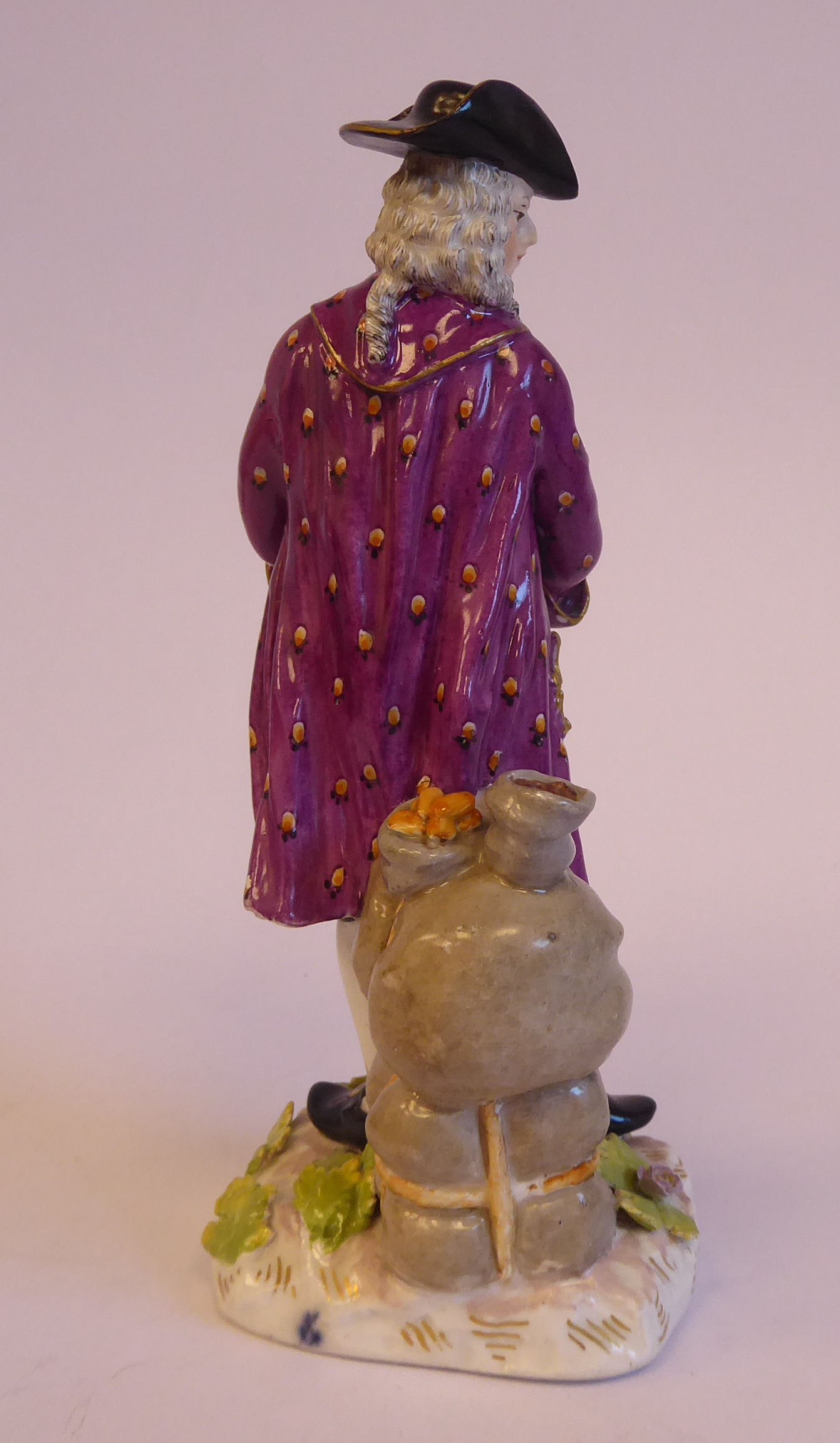A mid 19thC Continental porcelain figure, a standing merchant, wearing a tricorn hat, wig, - Bild 3 aus 7