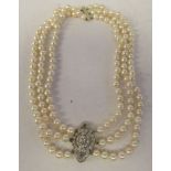 A white gold and diamond set, triple row pearl necklace,