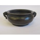 An Oriental cast and patinated bronze footed censer, the shallow,