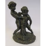 A cast and patinated bronze group, two cherubic figures, on a naturalistic base 15.