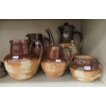 Seven items of Doulton Lambeth and Royal Doulton two tone brown glazed stoneware tea/coffee ware,