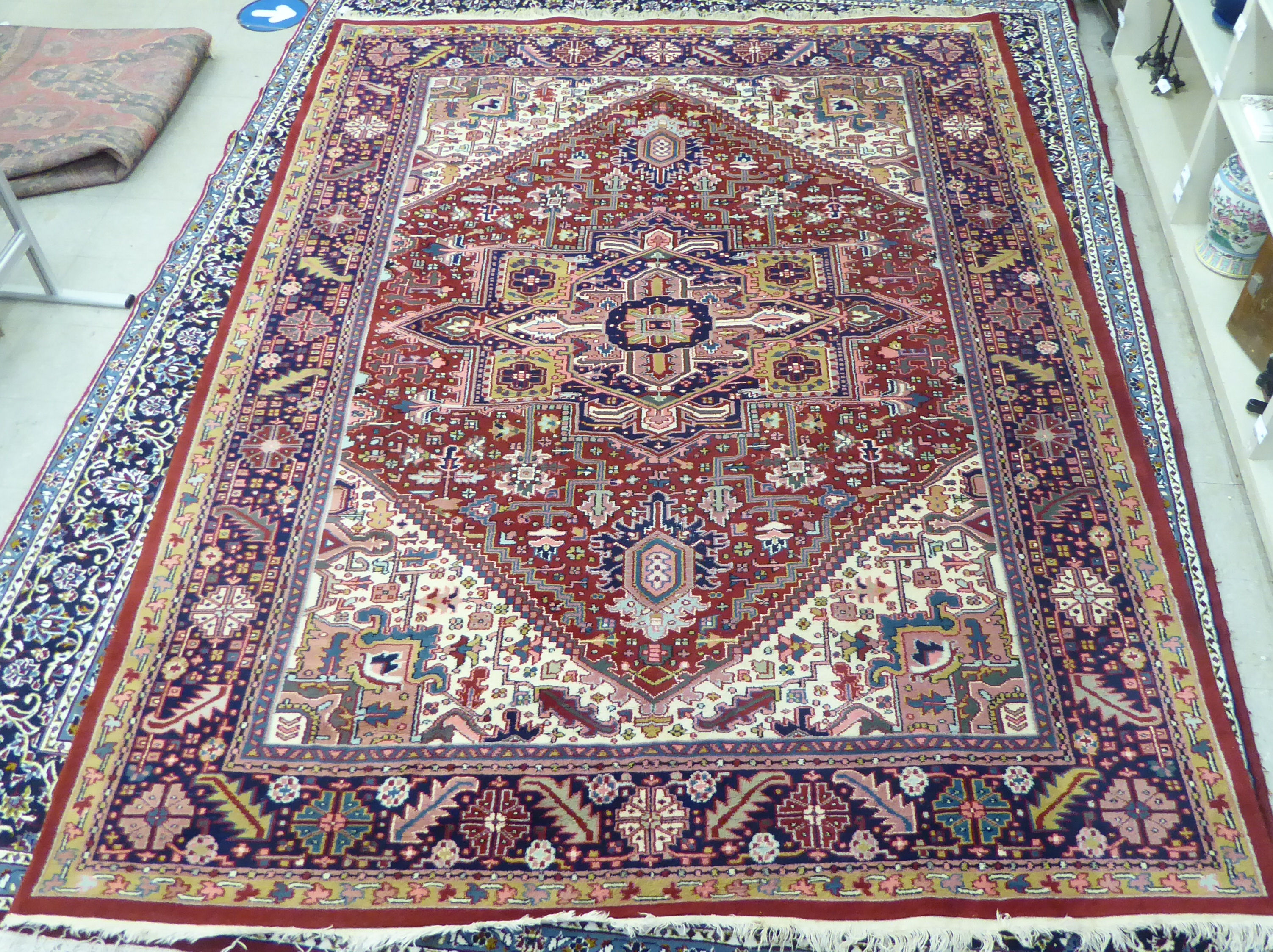 A Persian carpet, decorated with repeating geometric designs,