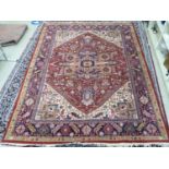 A Persian carpet, decorated with repeating geometric designs,
