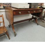 A George III crossbanded and ebony inlaid mahogany sofa table with a pair of frieze drawers and two