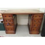 A modern mahogany twin pedestal desk with two frieze drawers, over two cupboard doors,