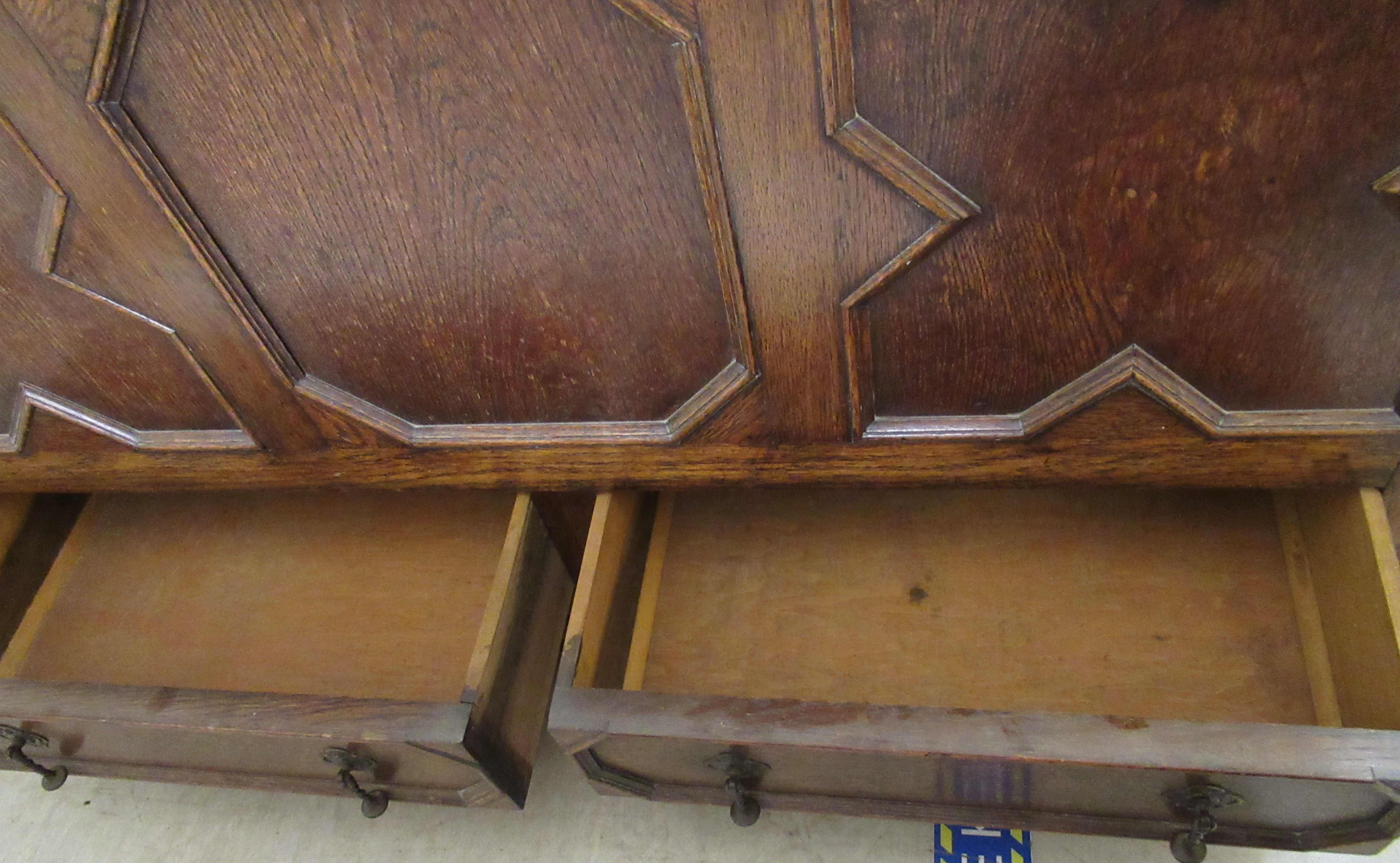 A 1930s oak mule chest with a hinged lid, over a tri-panelled front and two base drawers, - Image 4 of 4