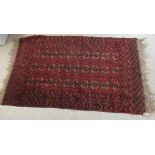 A Bokhara rug, decorated with three columns of ten octagonal guls,