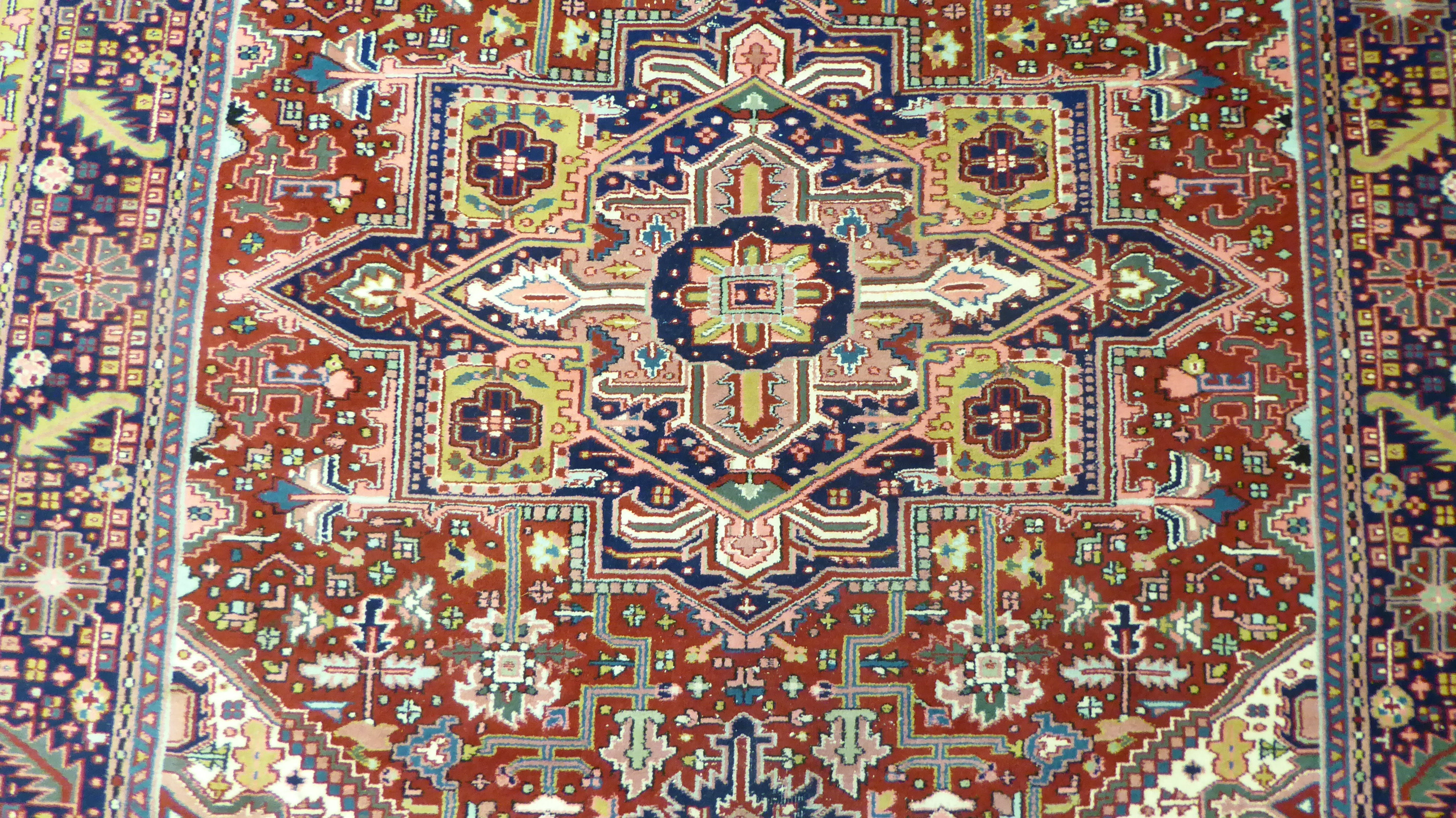 A Persian carpet, decorated with repeating geometric designs, - Image 3 of 5