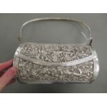 An Asian white metal handbag with a swing handle,