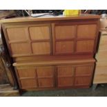 A pair of Nathan teak living room base units with multi-panelled doors,