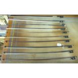 Ten violin bows,