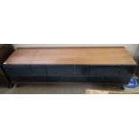 A modern teak finished entertainment unit with two drawers,