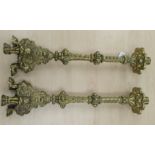 A pair of mid 20thC ornately cast brass candlesticks,