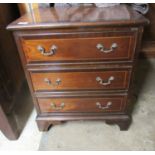 A modern Georgian inspired string inlaid mahogany three drawer chest with bail handles,