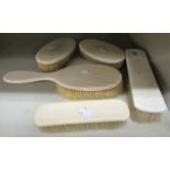 An Edwardian gentleman's set of five ivory backed hairbrushes OS3