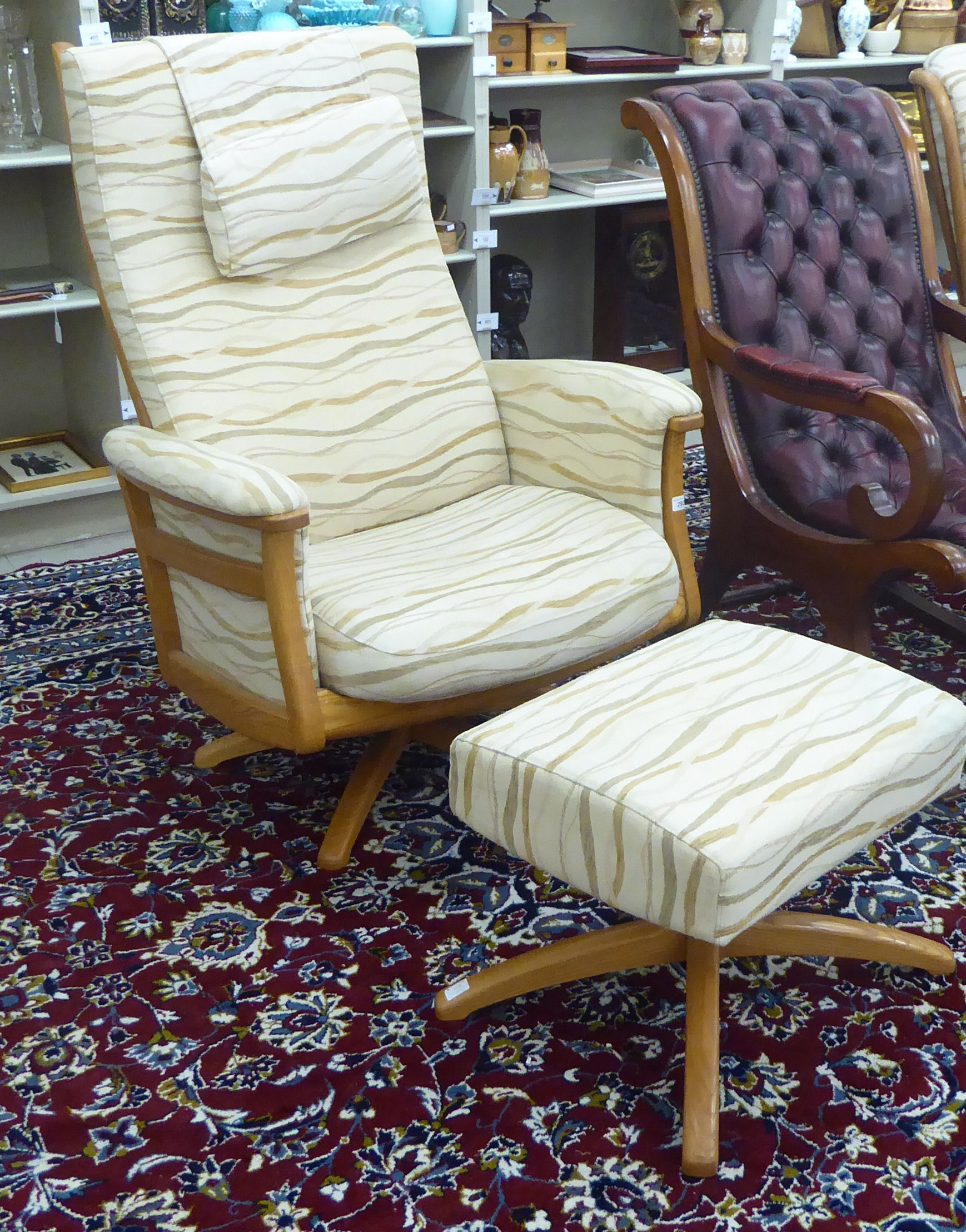 An Ercol light coloured beech framed ladderback, enclosed arm chair,