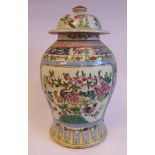 An early 20thC Chinese porcelain jar of waisted baluster form, having a domed cover and knop finial,