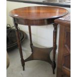 A 1920s stained oak occasional table, raised on slender, turned legs,