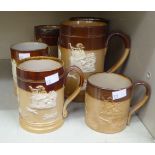 Six similar Doulton Lambeth and Royal Doulton two tone brown glazed stoneware tankards of