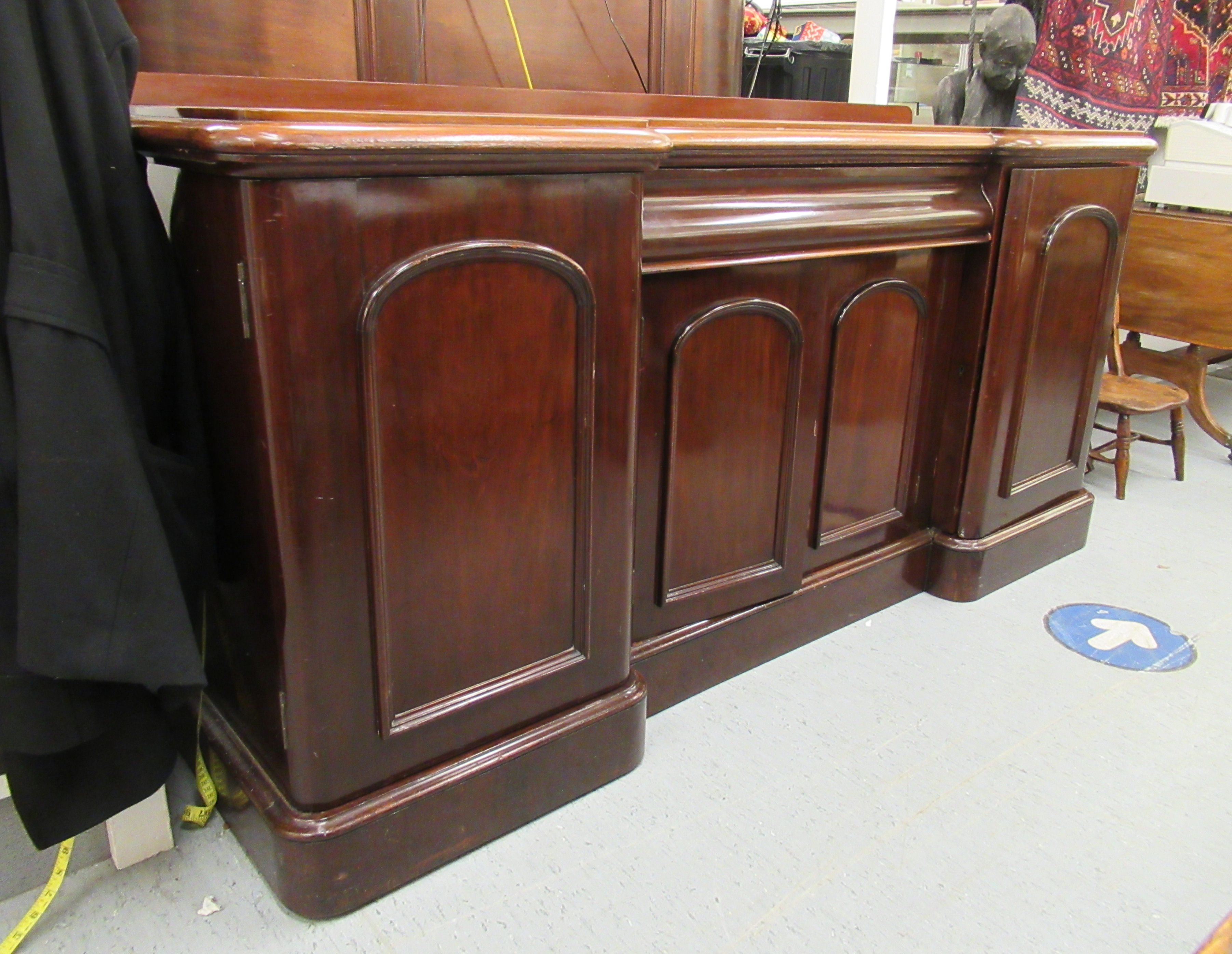 A mid Victorian mahogany chiffonier, the breakfront top, over three cupboard sections,