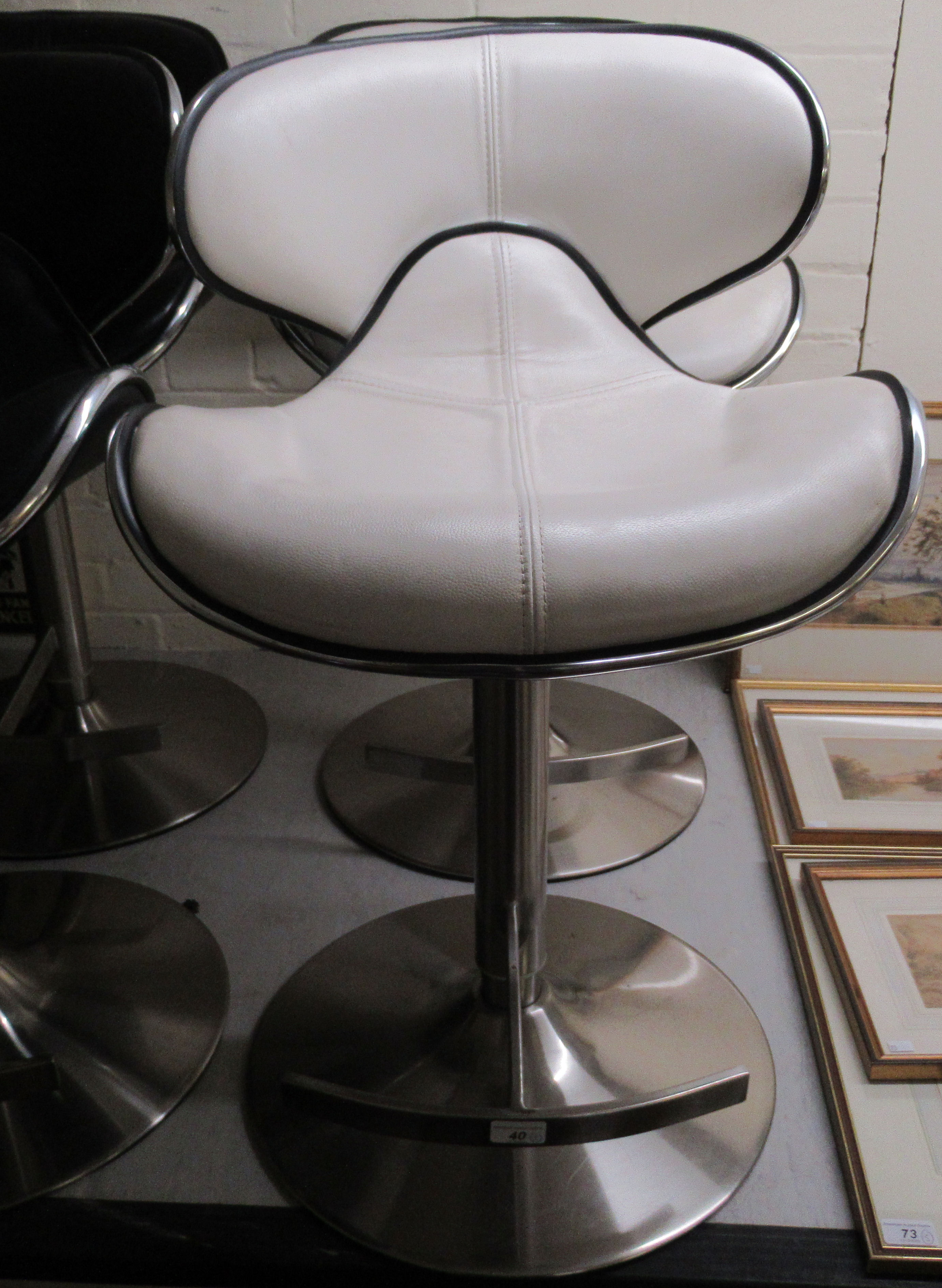 A pair of modern white hide upholstered breakfast stools,