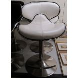 A pair of modern white hide upholstered breakfast stools,