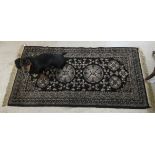 A woollen rug, decorated with circular and stylised floral designs,