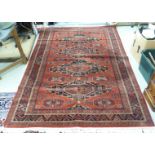 A machine made Persian design rug, decorated with four central, octagonal guls,