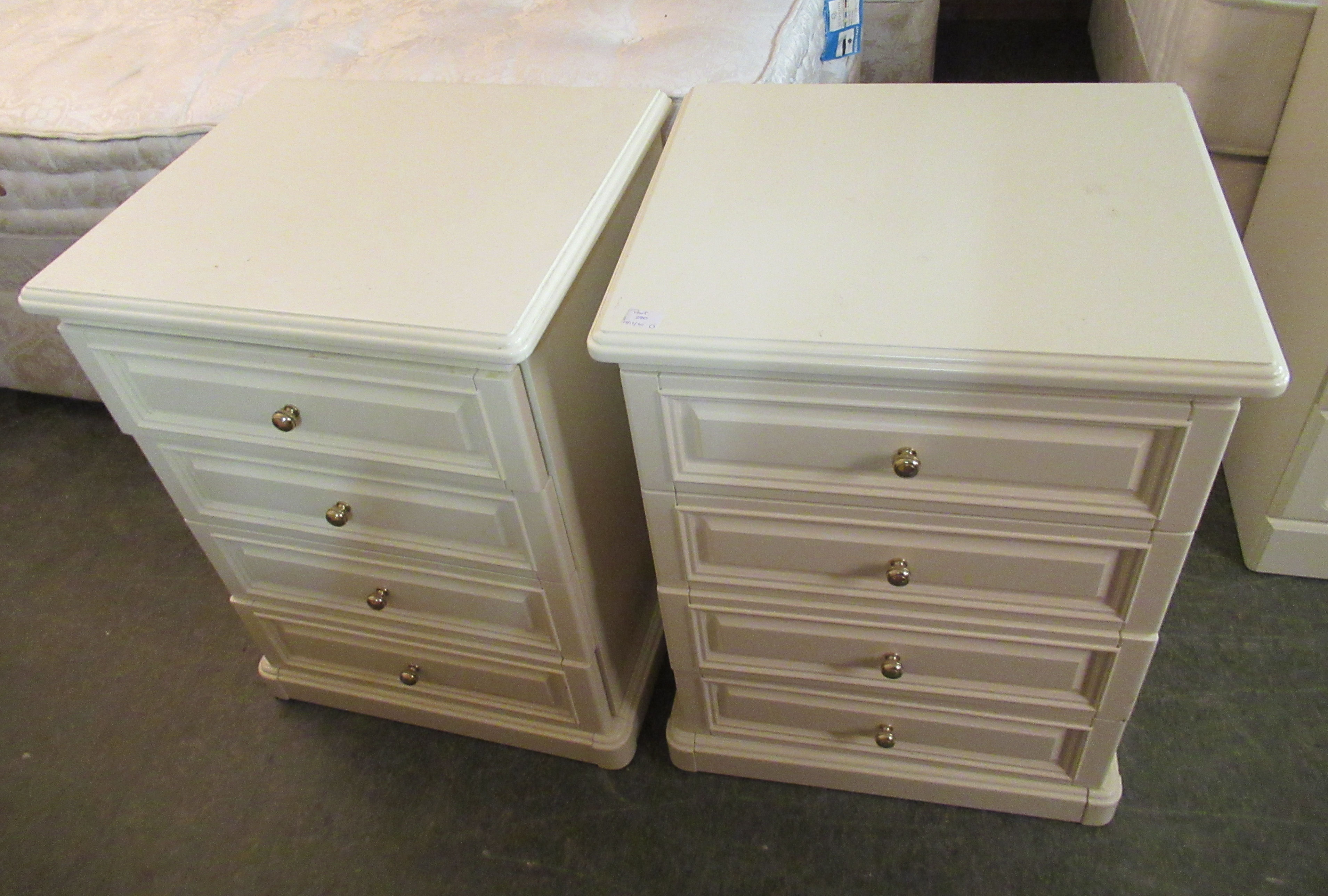 A pair of modern cream coloured laminated four drawer bedside chests 27''h 21''w; - Image 2 of 3